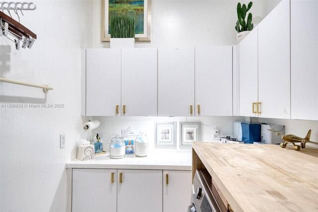 kitchen featuring white cabinetry and washer / clothes dryer