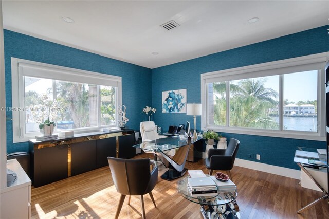 office area featuring hardwood / wood-style floors and a water view