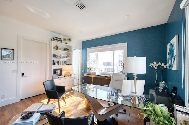 home office with light hardwood / wood-style floors