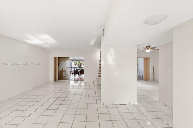 tiled empty room featuring ceiling fan