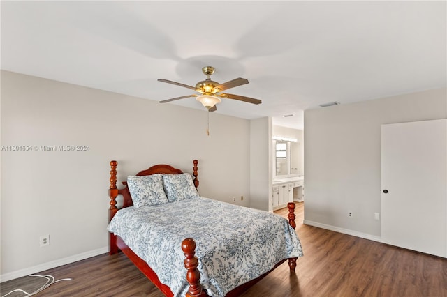 bedroom featuring dark hardwood / wood-style floors, ensuite bathroom, and ceiling fan