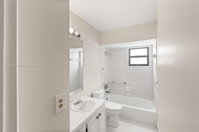 full bathroom featuring tile flooring, toilet, tiled shower / bath, and oversized vanity