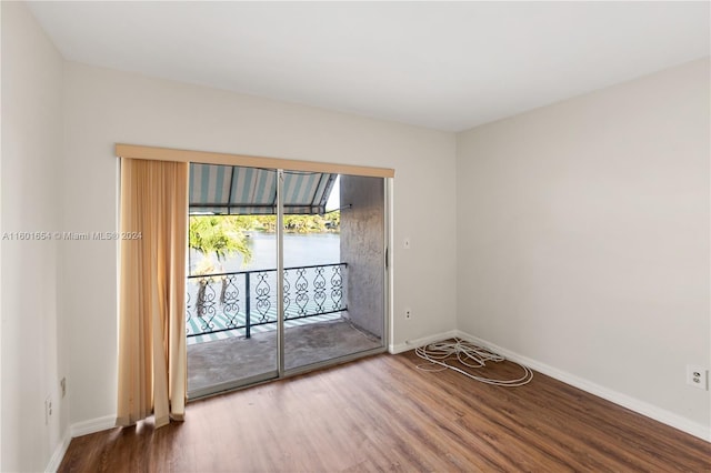 unfurnished room featuring hardwood / wood-style flooring