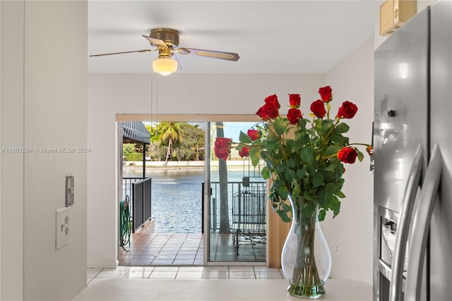 interior space with ceiling fan, stainless steel fridge with ice dispenser, and light tile floors