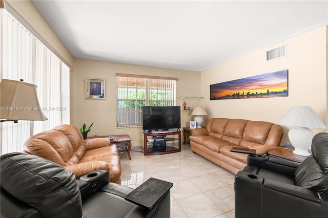 living room featuring light tile patterned flooring and ornamental molding