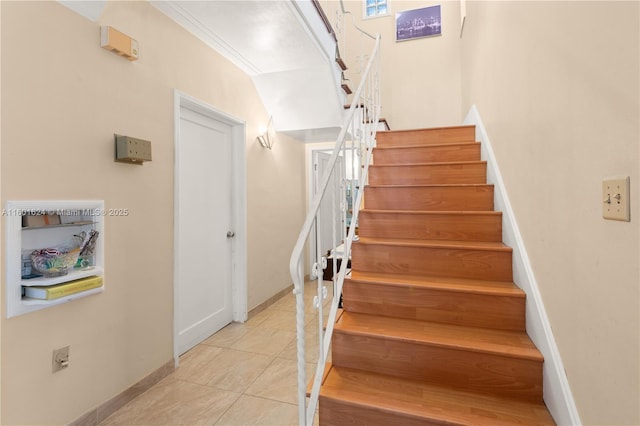 stairway featuring tile patterned flooring and ornamental molding