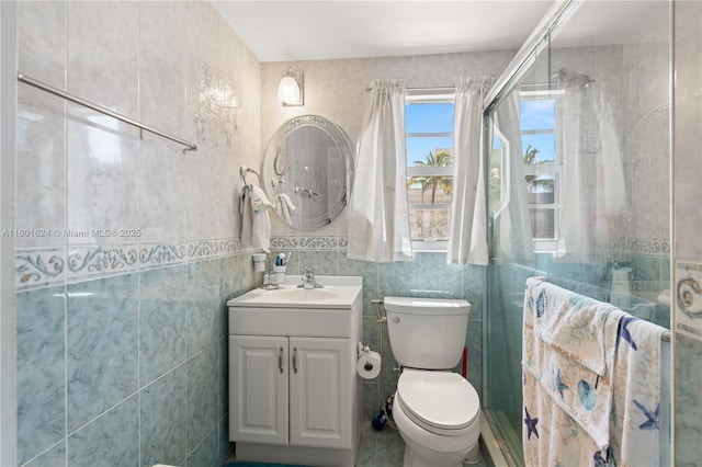 bathroom featuring tile walls, an enclosed shower, vanity, and toilet