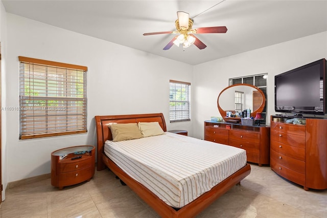 bedroom with ceiling fan and light tile patterned floors