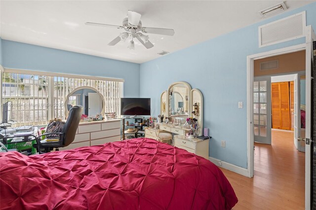 bedroom with light wood-type flooring and ceiling fan