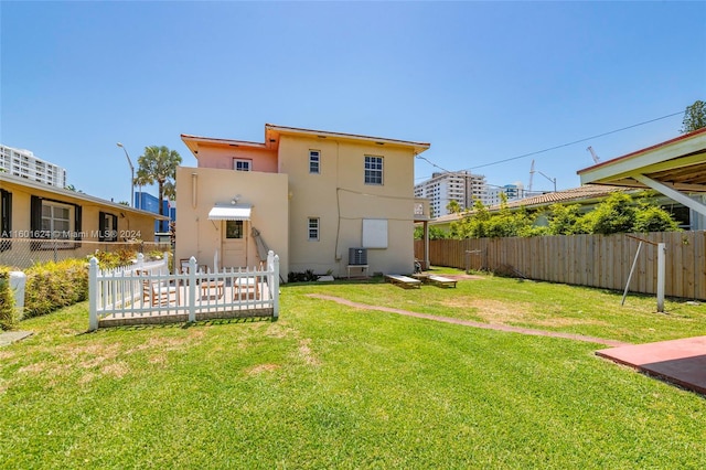 rear view of property with a yard