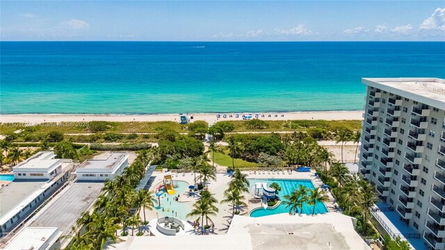 bird's eye view with a water view and a beach view