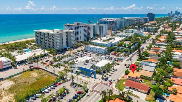 bird's eye view with a view of the beach and a water view