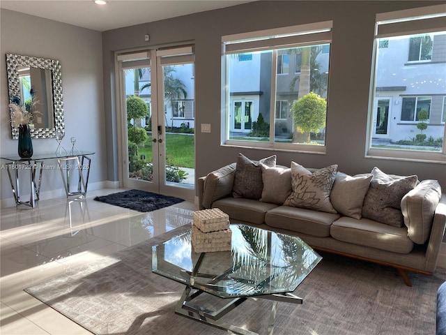 tiled living room featuring french doors, baseboards, and recessed lighting