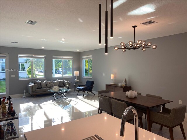 dining room featuring a notable chandelier and a textured ceiling