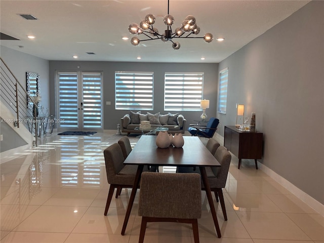 dining room with visible vents, a chandelier, baseboards, stairs, and light tile patterned floors