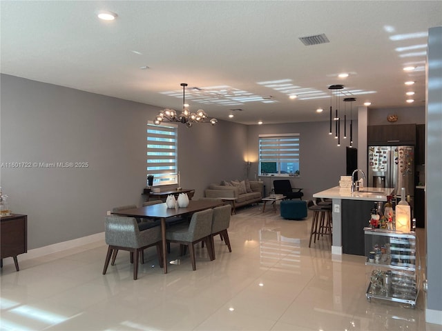 dining area featuring light tile patterned floors, baseboards, visible vents, recessed lighting, and an inviting chandelier