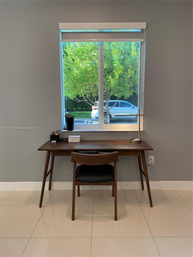 home office featuring tile patterned flooring and baseboards