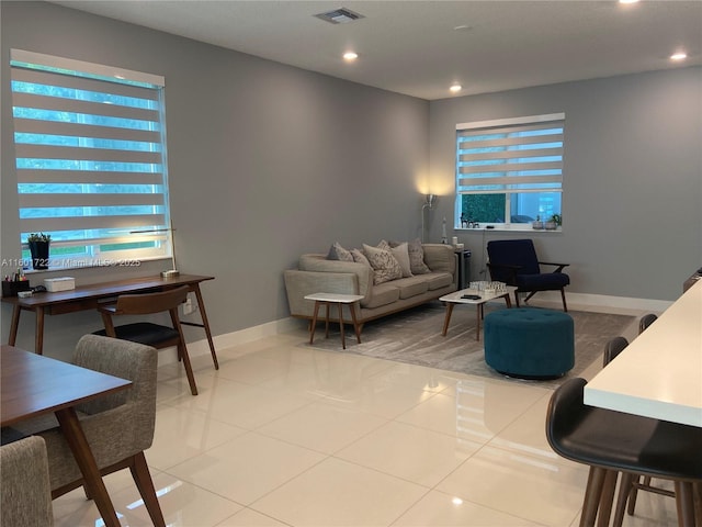 living room with light tile patterned flooring, baseboards, visible vents, and recessed lighting