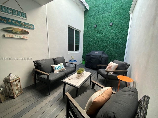 wooden deck featuring an outdoor living space and area for grilling