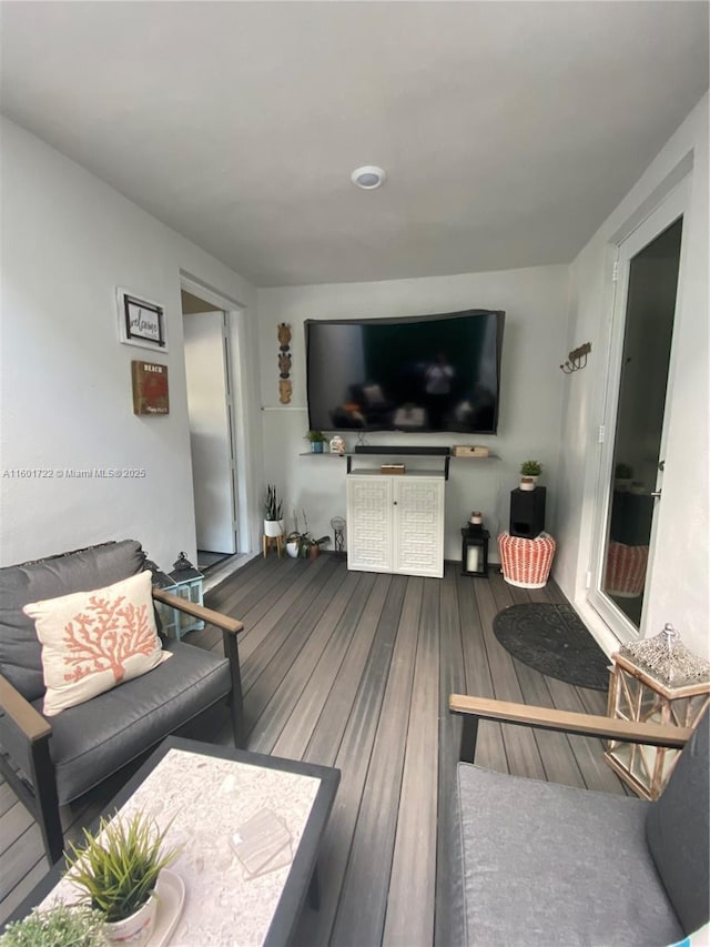 living area with hardwood / wood-style floors
