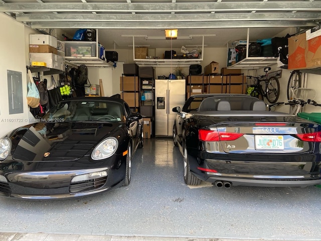 garage with stainless steel fridge with ice dispenser, electric panel, and a garage door opener