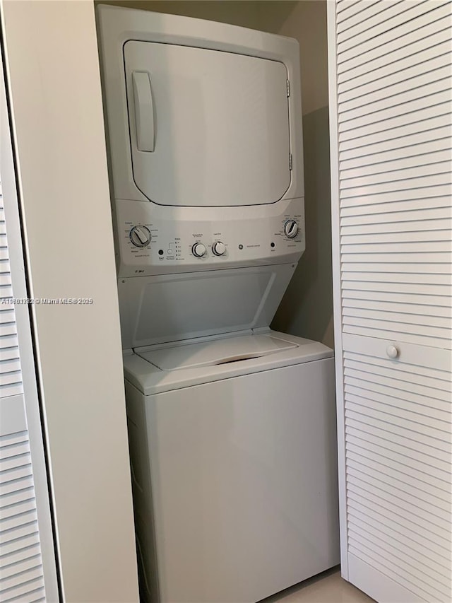 laundry area featuring stacked washer and dryer and laundry area