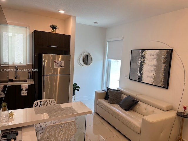 living area with light tile patterned floors and recessed lighting
