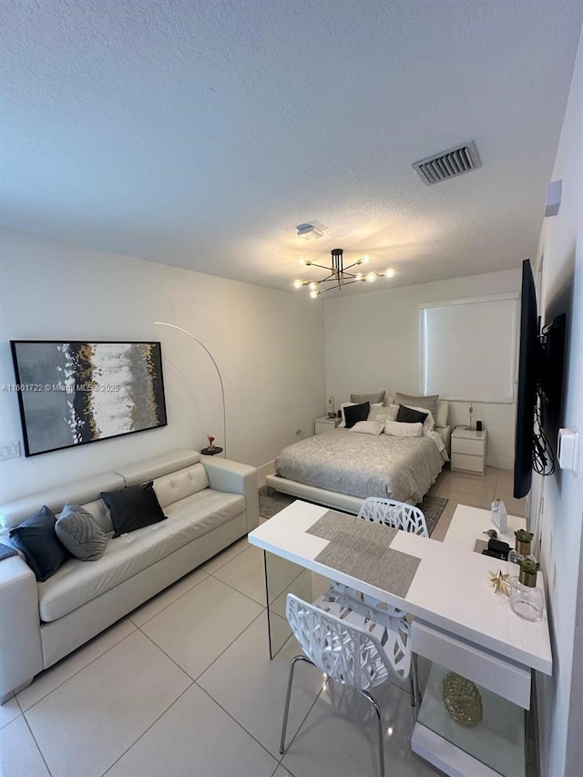 bedroom with visible vents, light tile patterned floors, and a textured ceiling