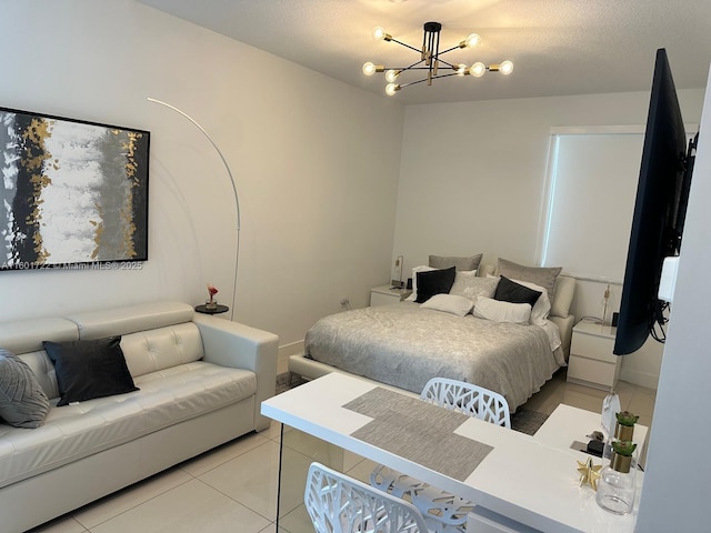 bedroom featuring light tile patterned flooring, a notable chandelier, and a textured ceiling