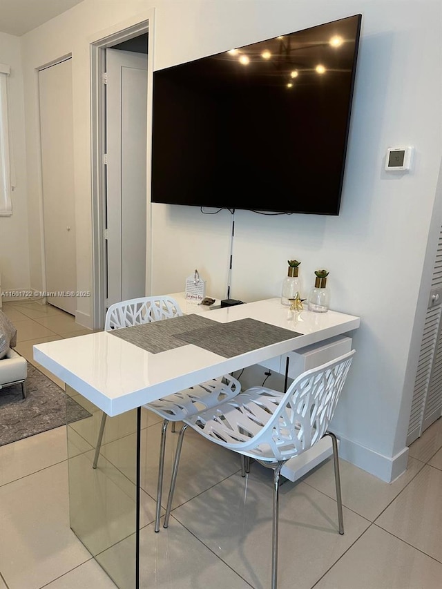 living room with light tile patterned floors and baseboards