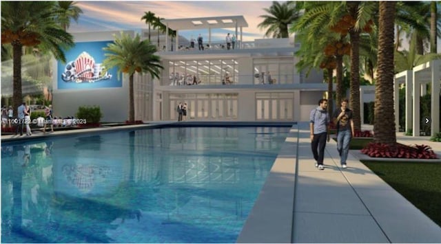 pool at dusk with a community pool