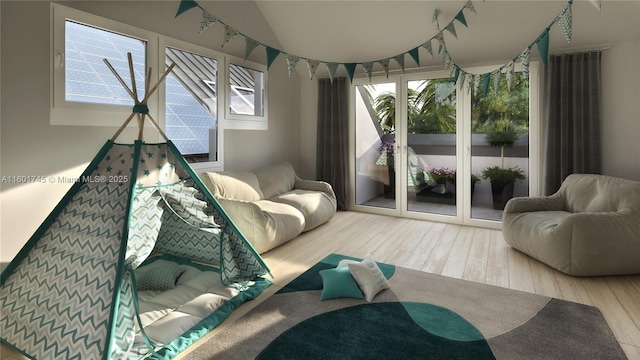 sitting room featuring vaulted ceiling and wood-type flooring