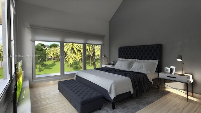 bedroom featuring lofted ceiling and light hardwood / wood-style flooring