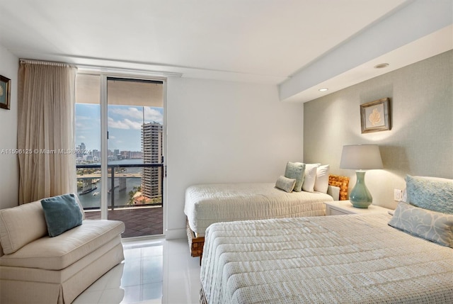 bedroom with a water view, light tile patterned floors, and access to outside