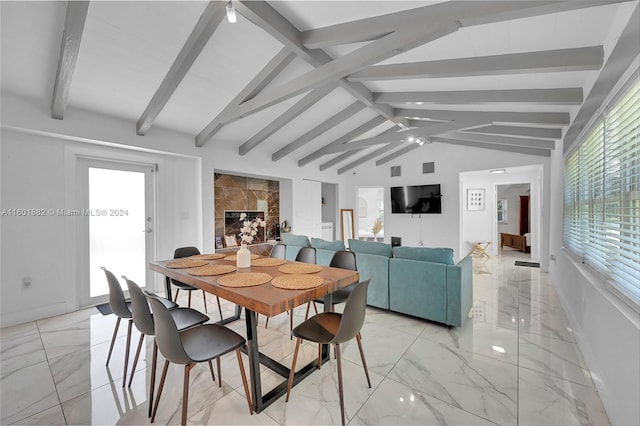 dining room featuring baseboards, lofted ceiling with beams, and marble finish floor