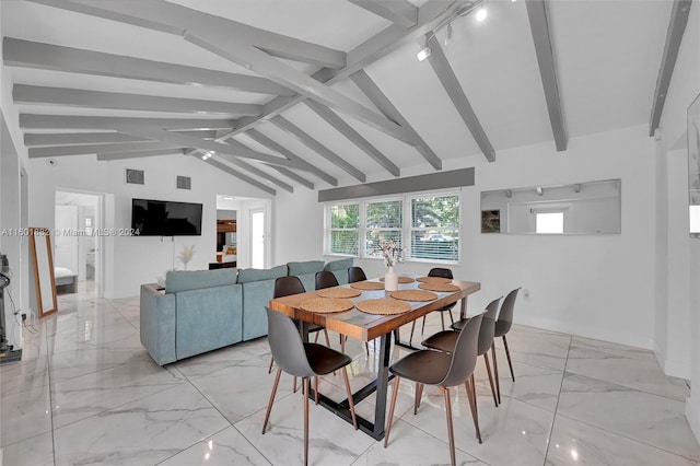 dining room with lofted ceiling with beams