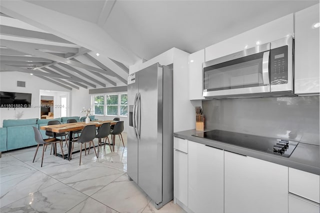 kitchen featuring modern cabinets, white cabinets, vaulted ceiling with beams, and stainless steel appliances