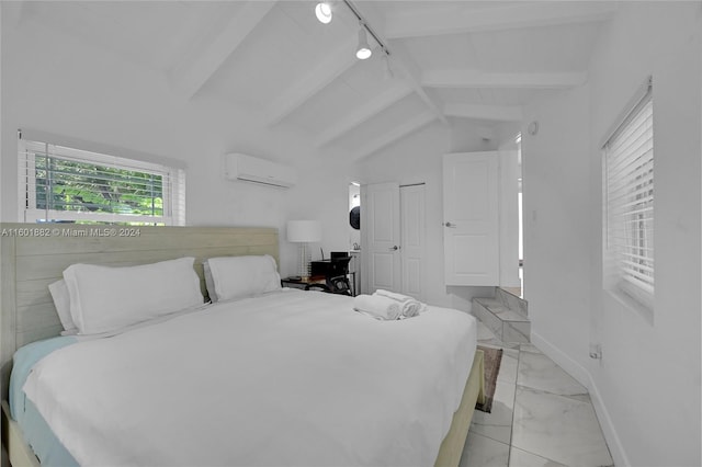 bedroom featuring vaulted ceiling, track lighting, and a wall mounted air conditioner