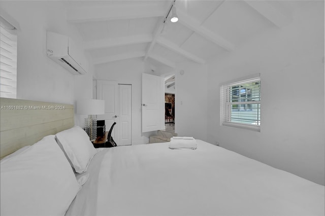 bedroom featuring track lighting, a wall unit AC, and lofted ceiling with beams