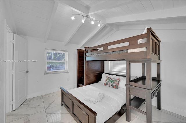 bedroom with lofted ceiling with beams, marble finish floor, and baseboards