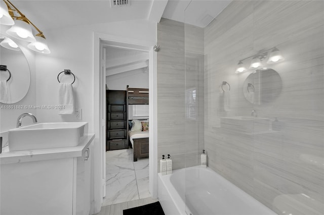 full bathroom with a sink, ensuite bath, marble finish floor, double vanity, and lofted ceiling