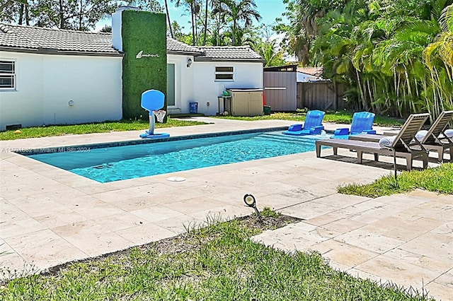 view of pool featuring a patio, fence, and a fenced in pool