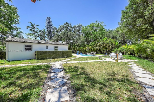 view of yard featuring an outdoor pool