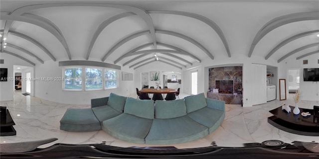 living room featuring washer / dryer and vaulted ceiling