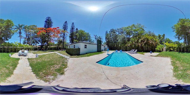 view of pool featuring a yard and a patio