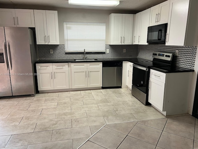 kitchen featuring tasteful backsplash, white cabinetry, sink, and stainless steel appliances