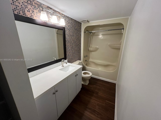 full bathroom featuring bathing tub / shower combination, hardwood / wood-style floors, vanity, and toilet