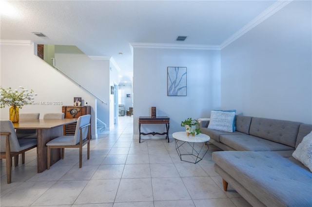 living room featuring ornamental molding and light tile patterned floors