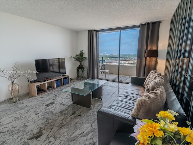 living room with floor to ceiling windows and a textured ceiling