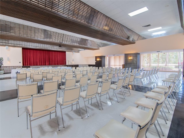 cinema with concrete flooring and a towering ceiling